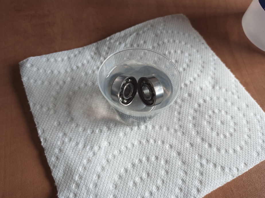 two bearings soaking in alcohol
