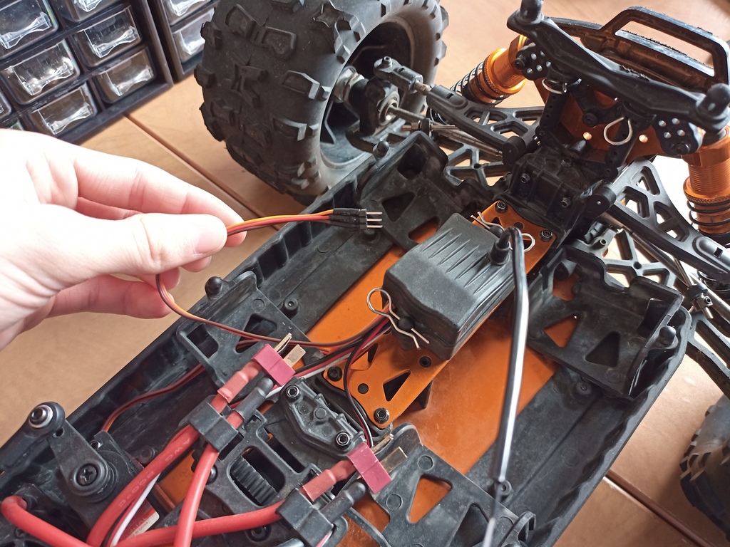 holding a servo connector above the car